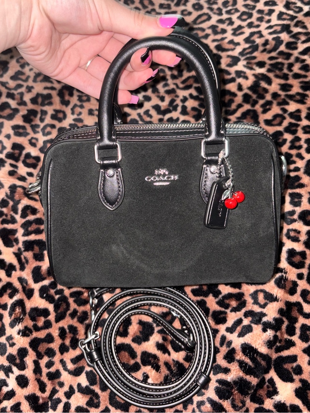 Coach mini rowan bag with cherry charm in black suede with crossbody strap